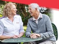 A Salvation Army Aged Care Plus worker talks with a senior gentleman