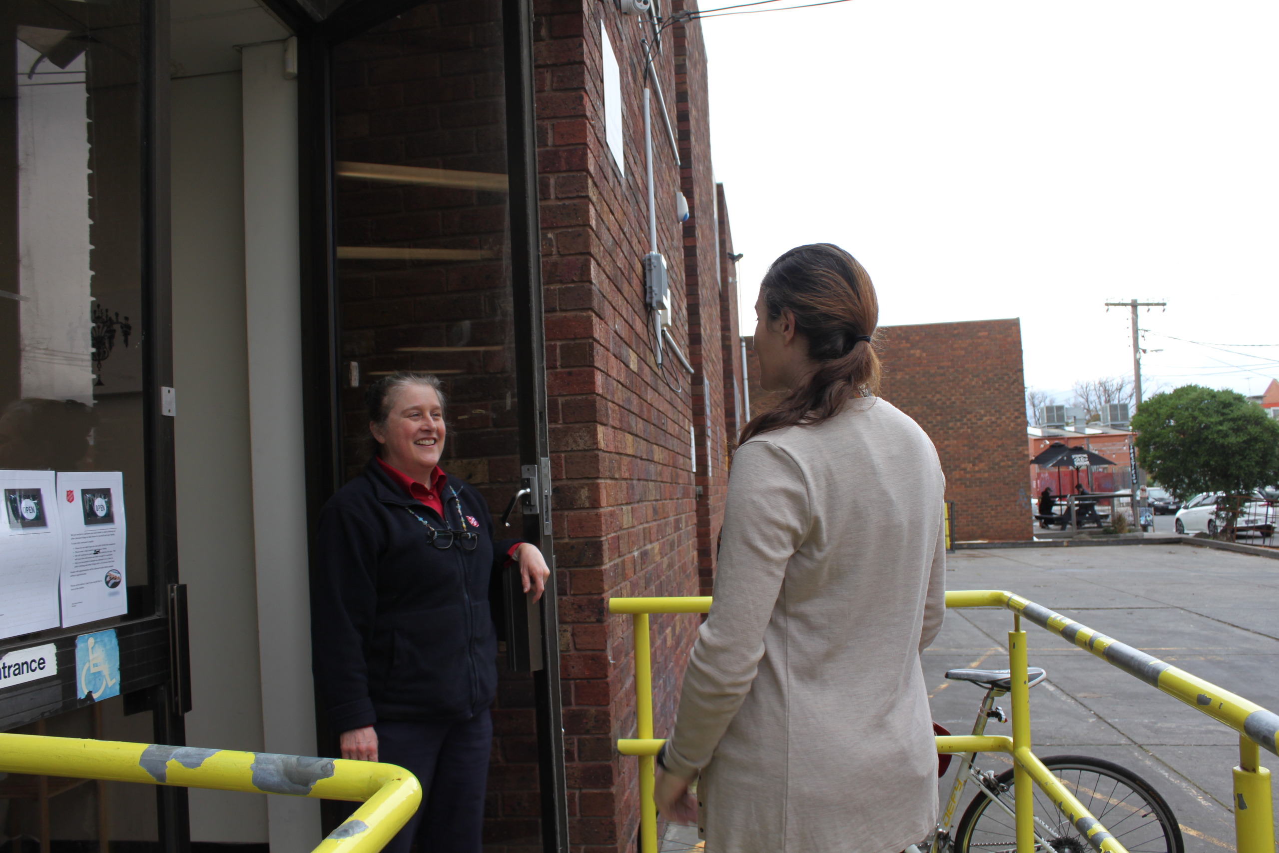 Karen welcoming a woman to The Salvation Army Asylum Seeker and Refugee Service