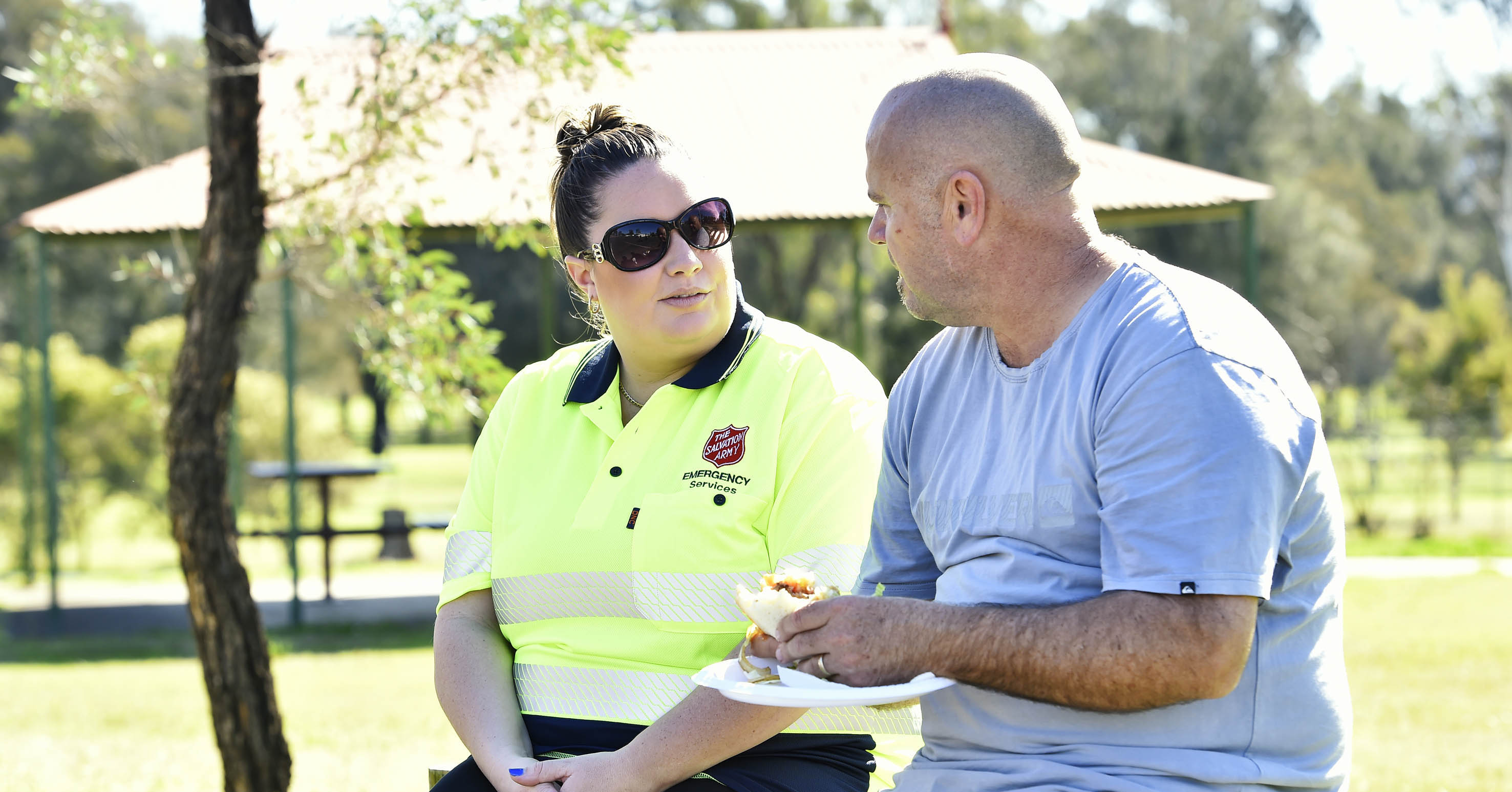 Salvos emergency services volunteer talking to bald man